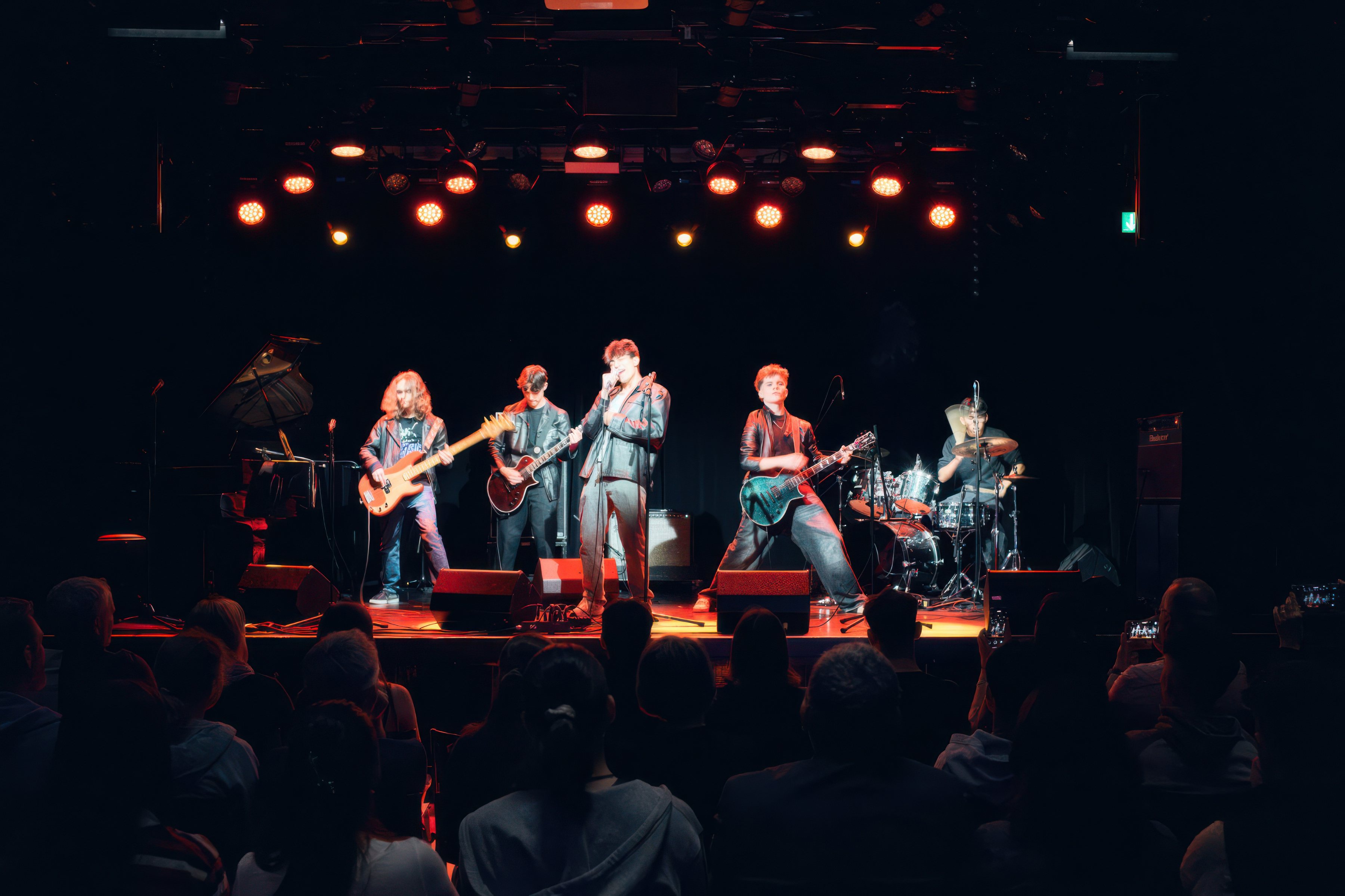 A six-piece band performs for an audience.